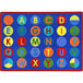 A white, blue, and multi-colored rectangle area rug with letters and numbers on it.