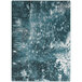 A close up of a blue and white Joy Carpets Riviera rectangular area rug with a watery effect.