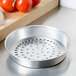 An American Metalcraft round silver aluminum pizza pan with holes.