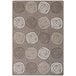 A Joy Carpets rectangular area rug with brown circles and swirls on it.