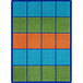 A Joy Carpets rectangular area rug with blue, orange, and green squares.