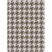 A white rug with brown hounds tooth pattern.