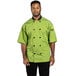 A man wearing a Uncommon Chef Havana green short sleeve chef coat with mesh back.