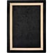 A black and beige rectangular area rug with a white border.