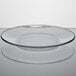 An Anchor Hocking clear glass plate with a clear rim on a white surface.