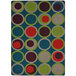 A Joy Carpets rectangle area rug with blue, green, and red circles on a blue background.