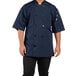 A man wearing a navy Uncommon Chef short sleeve chef coat with mesh back.