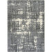 A close-up of a grey and white Joy Carpets Westmarch rectangular area rug with a distressed pattern.
