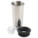 A close-up of a silver stainless steel cup with a black plastic lid.