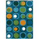 A blue rug with green, orange, and white circles.