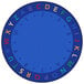 A white and multicolored round rug with letters and numbers in a blue circle.