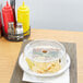 A clear plastic Carlisle plate cover on a plate with food.