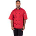 A man wearing a Uncommon Chef red chef coat with a mesh back.