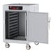 A Metro C5 heated holding cabinet with solid doors and wheels.