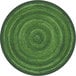 A green circular rug with a circular pattern and a black border.