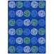 A blue rug with white and green swirls and circles.