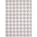 A taupe area rug with a houndstooth pattern in white.