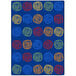 A blue rectangular area rug with colorful circles.