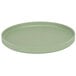 A green round Cal-Mil Melamine plate with a low rim.