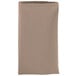 A folded beige Intedge cloth napkin.