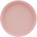 A close-up of a pink Cal-Mil melamine plate with a low rim.