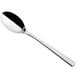 A Sola stainless steel dessert spoon with a long black handle.