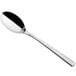 A Sola stainless steel dessert spoon with a long black handle.