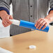 A man holding a blue Lavex mailing tube with a blue cap.