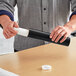 A person holding a Lavex black mailing tube