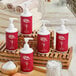 A group of red and white Noble Eco Novo Natura conditioning shampoo bottles on a wooden shelf.