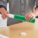 A man holding a green Lavex mailing tube.
