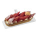 A white rectangular Solia bagasse pastry display filled with strawberry tarts.