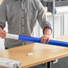 A man holding a blue Lavex mailing tube
