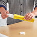 A man holding a yellow Lavex mailing tube.