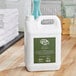 A white plastic container of Noble Eco Novo Terra shampoo on a wood table.