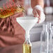 A person pouring liquid into a funnel.