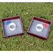 Two square wooden boxes with white circles and red and blue rings on them.