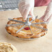 A person using a Choice 9" aluminum pie and cake marker to cut a pie.