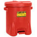 A red Eagle Manufacturing oily waste can with a yellow and black hazardous warning label.