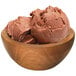 A bowl of G.S. Gelato Nutella gelato with a scoop on a table.