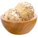 A wooden bowl with two scoops of G.S. Gelato BUTTERFINGER® gelato.