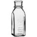 A clear glass Muth honey jar with a cap.