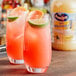 A table with two glasses of white grapefruit juice with lime slices and ice.