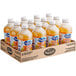 A group of Ocean Spray Pineapple Juice bottles in a cardboard box.