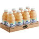 A cardboard box with eight bottles of Ocean Spray Pure 100% White Grapefruit Juice on a white background.