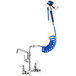 A Waterloo pet grooming faucet with blue coiled hose attached.