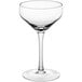 An Acopa Silhouette clear coupe glass with a stem on a white background.