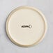 An Acopa Pangea fog white matte coupe porcelain plate with black text that says "Acopa"