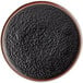 An Acopa Heika black matte textured coupe stoneware plate with a brown border.