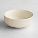 An Acopa Pangea fog white matte porcelain nappie bowl on a white surface.